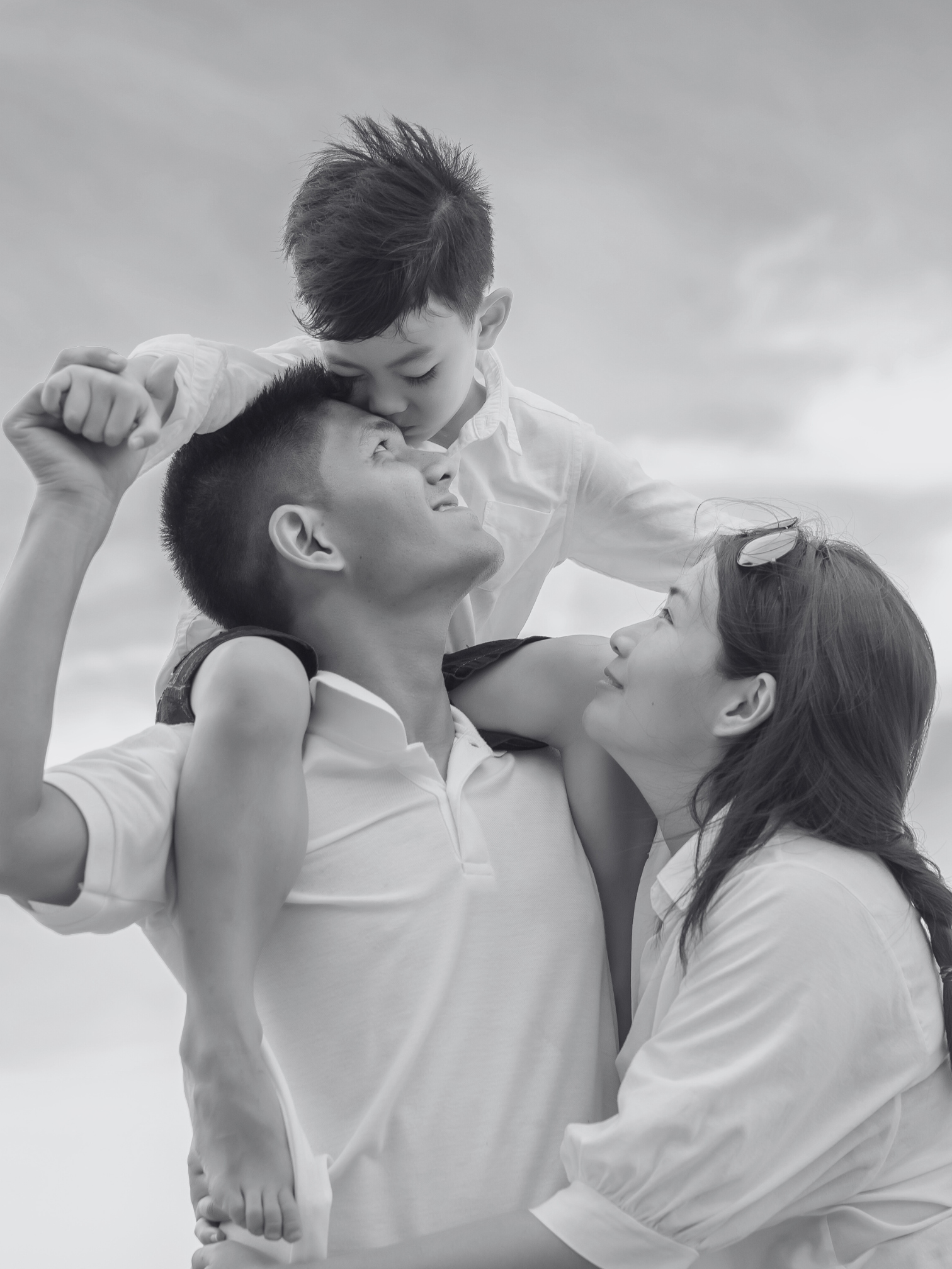 an image of a father, mother, and child smiling